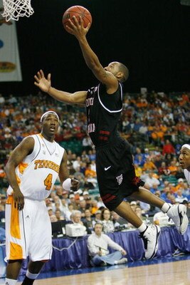 ATLANTA - MARCH 14:  Devan Downey #2 of the South Carolina Gamecocks makes a shot over Wayne Chism #4 of the Tennessee Volunteers during the SEC Men's Basketball Tournament on March 14, 2008 at the Georgia Dome in Atlanta, Georgia.  (Photo by Chris Grayth