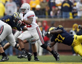 ANN ARBOR, MI - NOVEMBER 17:  Chris Wells #28 of the Ohio State Buckeyes runs past Chris Graham #37 of the Michigan Wolverines on November 17, 2007 at Michigan Stadium in Ann Arbor, Michigan.  (Photo by Gregory Shamus/Getty Images)