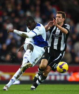 BLACKBURN, UNITED KINGDOM - JANUARY 17: Christopher Samba of Blackburn clears from Michael Owen of Newcastle during the Barclays Premier League match between Blackburn Rovers and Newcastle United at Ewood Park on January 17, 2009 in Blackburn, England.  (