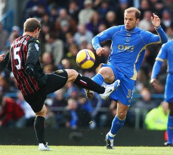 PORTSMOUTH, UNITED KINGDOM - FEBRUARY 14:  Angelos Basinas (R) of Portsmouth competes for the ball with Pablo Zabaleta (L) of Manchester City during the Barclays Premier League match between Portsmouth and Manchester City at Fratton Park on February 14, 2