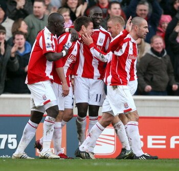 STOKE, UNITED KINGDOM - FEBRUARY 21:  Kevin Beattie of Stoke is congratulated after scores from the penalty spot during the Barclays Premiership match between Stoke City and Portsmouth at The Britanina Stadium on February 21, 2009 in Stoke,England.  (Phot