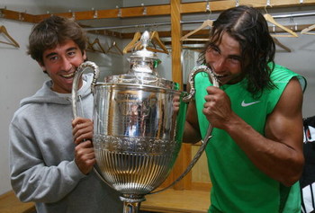 LONDON - JUNE 15: Rafael Nadal (R) of Spain and Marc Lopez of Spain pose with the trophy after Nadal's victory during the Men's Singles Final match against Novak Djokovic of Serbia on Day 7 of the Artois Championships at Queen's Club on June 15, 2008 in