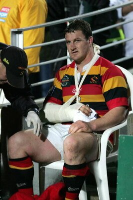 HAMILTON, NEW ZEALAND - SEPTEMBER 24:  Michael Collins sits on the side line with a broken arm heavily bandaged up during Waikato's First Division NPC game against Canterbury at Waikato Stadium in Hamilton, New Zealand, Friday, September 24 2004.  (Photo 