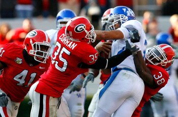 ATHENS, GA - NOVEMBER 17:  Quarterback Andre Woodson #3 of the Kentucky Wildcats is sacked by defenders Rennie Curran #35 and Marcus Howard #38 of the Georgia Bulldogs during the second half at Sanford Stadium on November 17, 2007 in Athens, Georgia.  Geo