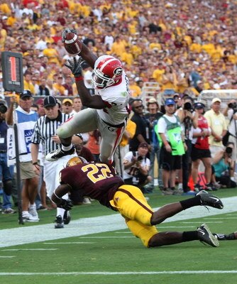 TEMPE, AZ - SEPTEMBER 20: Tailback Knowshon Moreno #24 of the Georgia Bulldogs dives over safty Rodney Cox #22 of the Arizona State Sun Devils for a touchdown on September 20, 2008 at Sun Devil Stadium in Tempe, Arizona.  (Photo by Stephen Dunn/Getty Imag