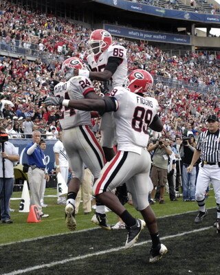 ORLANDO, FL - JANUARY 1: Running back Knowshon Moreno #24 of the University of Georgia celebrates a touchdown catch with Demiko Goodman #85 and Bruce Figgins #89 against the Michigan State Spartans during the 2009 Capital One Bowl at the Citrus Bowl on Ja