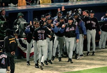 19 Oct 1999: Mike Piazza #31 of the New York Mets is greeted by the bench after his home run during the National League Championship Series game six against the Atlanta Braves at Turner Field in Atlanta, Georgia. The Braves defeated the Mets 10-9. Mandato