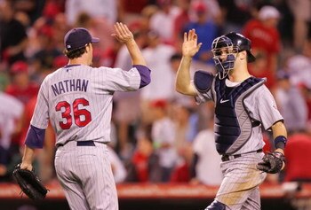 ANAHEIM, CA - AUGUST 21:  (L-R) Pitcher Joe Nathan #36 and catcher Joe Mauer #24 of the Minnesota Twins celebrate defeating the Los Angeles Angels of Anaheim 2-1 in 12 innings at Angels Stadium on August 21, 2008 in Anaheim, California.  (Photo by Lisa Bl
