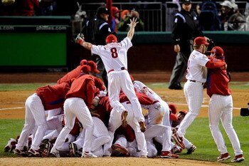 PHILADELPHIA - OCTOBER 29:  Shane Victorino #8 of the Philadelphia Phillies dives on top of his teammates as they pile on top of closing pitcher Brad Lidge #54 after they won 4-3 to win the World Series against the Tampa Bay Rays during the continuation o