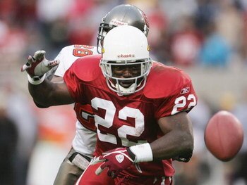 TEMPE, AZ - JANUARY 2:  Running back Emmitt Smith #22 of the Arizona Cardinals fumbles the ball out of bounds after being hit from behind by Dexter Jackson #28 of the Tampa Bay Buccaneers late in the fourth quarter at Sun Devil Stadium on January 2, 2005 