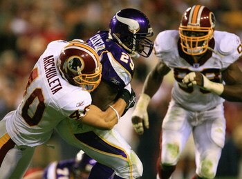 LANDOVER, MD - SEPTEMBER 11: Chester Taylor #29 of the Minnesota Vikings gets tackled by Adam Archuleta #40 from the Washington Redskins on the first Monday Night Football game of the season on September 11, 2006 at FedEx Field in Landover, Maryland. The 