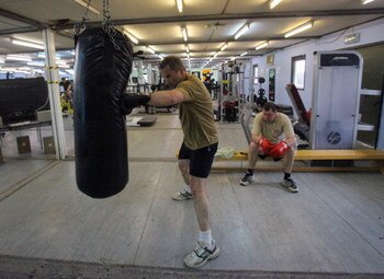 BASRA, IRAQ - FEBRUARY 10:  A British serviceman works out in the gym at the main British base, the Combined Operating Base (COB), at Basra Airport, on February 10, 2009 near Basra, Iraq. The vast tented camp is home to thousands of British service person