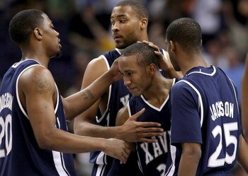 PHOENIX - MARCH 29:  Stanley Burrell #34 of the Xavier Musketeers is congratulated by teammates C.J. Anderson #20, Jason Love #31 and Dante' Jackson #25 as Burrell leaves the game in final minute of the West Regional Final for the last time as a Muskateer