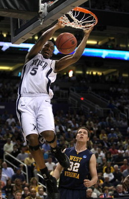 PHOENIX - MARCH 27:  Derrick Brown #5 of the Xavier Musketeers dunks the ball as Ted Talkington #32 of West Virginia Mountaineers looks on during the West Regional Sweet 16 game at the U.S. Airways Center on March 27, 2008 in Phoenix, Arizona.  (Photo by 