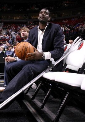 PORTLAND, OR - OCTOBER 10:  Greg Oden #52 of the Portland Trail Blazers, who is out for the season after under going micro fracture surgery in his knee, sits on the bench to watch a pre-season game against the Los Angeles Clippers at the Rose Garden on Oc