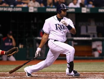 ST PETERSBURG, FL - OCTOBER 18:  Carl Crawford #13 of the Tampa Bay Rays hits a single against the Boston Red Sox in the fourth inning of game six of the American League Championship Series during the 2008 MLB playoffs on October 18, 2008 at Tropicana Fie