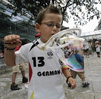 STUTTGART, GERMANY - JULY 08:  A German boy blows bubbles ahead the German World Cup match on July 8, 2006 in Stuttgart, Germany. Germany faces Portugal in their FIFA World Cup 2006 third-round play-off football in Stuttgart.  (Photo by Ralph Orlowski/Get