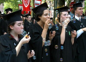CAMBRIDGE, MA - JUNE 9:  Unidentified Harvard University students celebrate by blowing bubbles during Harvard University Commencement exercises June 9, 2005 in Cambridge, Massachusetts. Actor John Lithgow, a Harvard alumnus, was awarded an honorary degree