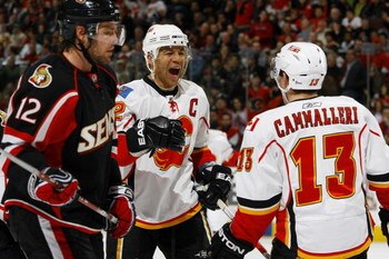 OTTAWA - MARCH 3:  Jarome Iginla #12 of the Calgary Flames celebrates his go-ahead goal with teammate Michael Cammalleri #13 while Mike Fisher #12 of the Ottawa Senators looks on on March 3, 2009 at the Scotiabank Place in Ottawa, Canada. (Photo by Philli