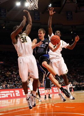 NEW YORK - NOVEMBER 21:  Jon Scheyer #30 of the Duke Blue Devils goes to the basket between DeShawn Sims #34 and Manny Harris #3 of the Michigan Wolverines on November 21, 2008 at Madison Square Garden in New York City.  (Photo by Nick Laham/Getty Images)