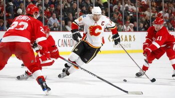 DETROIT - DECEMBER 10:  Brad Stuart #23 and Dan Cleary #11 both of the Detroit Red Wings defend against Jarome Iginla #12 of the Calgary Flames during their NHL game at Joe Louis Arena December 10, 2008 in Detroit, Michigan.(Photo By Dave Sandford/Getty I