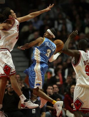 CHICAGO - FEBRUARY 22: Allen iverson #3 of the Denver Nuggets leaps to pass the ball between Joakim Noah #13 (L) and Luol Deng #9 of the Chicago Bulls on February 22, 2008 at the United Center in Chicago, Illinois. NOTE TO USER: User expressly acknowledge