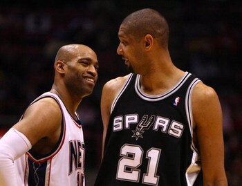 EAST RUTHERFORD, NJ - FEBRUARY 10:  Vince Carter #15 of the New Jersey Nets talks to Tim Duncan #21 of the San Antonio Spurs during their game on February 10, 2009 at The Izod Center in East Rutherford, New Jersey.  NOTE TO USER: User expressly acknowledg