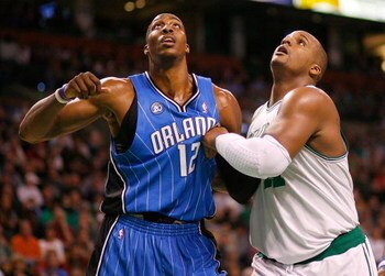 BOSTON, MA - MARCH 8:  Glen David #11 of the Boston Celtics battles Dwight Howard #12 of Orlando Magic for a rebound at the TD Banknorth Garden on March 8, 2009 in Boston, Massachusetts. The magic won 86-79. NOTE TO USER: User expressly acknowledges and a