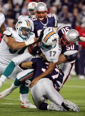 FOXBORO, MA - DECEMBER 23:  Rodney Harrison #37 and Mike Vrabel #50 of the New England Patriots sack Cleo Lemon #17 of the Miami Dolphins during their game at Gillette Stadium on December 23, 2007 in Foxboro, Massachusetts.  (Photo by Jim McIsaac/Getty Im
