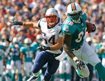 FOXBORO, MA - SEPTEMBER 21: David Martin #88 of the Miami Dolphins gets by Tedy Bruschi #54 of the New England Patriots at Gillette Stadium on September 21, 2008 in Foxboro, Massachusetts. The Dolphins won 38-13. (Photo by Jim Rogash/Getty Images)