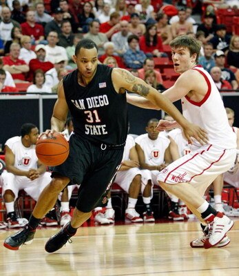 LAS VEGAS - MARCH 14:  Lorrenzo Wade #31 of the San Diego State Aztecs drives around Luka Drca #5 of the Utah Utes during the championship game of the Conoco Mountain West Conference tournament at the Thomas & Mack Center March 14, 2009 in Las Vegas, Neva