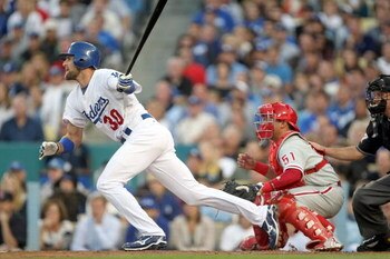 LOS ANGELES, CA - OCTOBER 12:  Casey Blake #30 of the Los Angeles Dodgers hit an RBI single to score Andre Ethier #16 in the bottom of the first inning against the Philadelphia Phillies in Game Three of the National League Championship Series during the 2