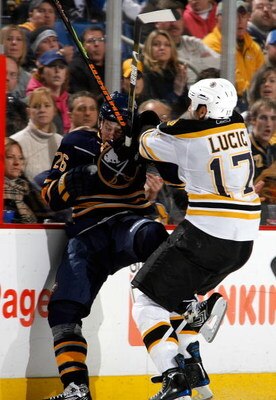 BUFFALO, NY - NOVEMBER 26: Thomas Vanek #26 of the Buffalo Sabres is checked by Milan Lucic #17 of the Boston Bruins at HSBC Arena November 26, 2008 in Buffalo, New York.  (Photo by Rick Stewart/Getty Images)