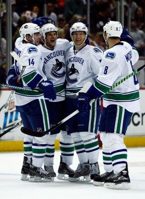 ANAHEIM, CA - OCTOBER 31:  (L-R) Alex Burrows #14, Kevin Bieksa #3, Jannik Hansen #36 and Willie Mitchell #8 of the Vancouver Canucks celebrate Bieksa's goal in the second period against the Anaheim Ducks looks at the Honda Center on October 31, 2008 in A