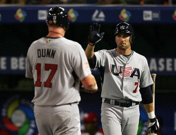 MIAMI - MARCH 14:  Adam Dunn #17 of the United States is congratulated by Mark DeRosa #7 after scoring against Puerto Rico during round 2 of the World Baseball Classic at Dolphin Stadium on March 14, 2009 in Miami, Florida. Puerto Rico defeated the United