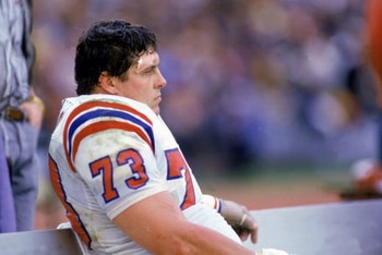 1985:  Offensive linebacker John Hannah #73 of the New England Patriots sits on the sideline during a 1985 NFL game.  (Photo by Rick Stewart/Getty Images)