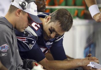GLENDALE, AZ - FEBRUARY 03:  Quarterback Tom Brady #12 of of the New England Patriots sits on the bench with Offensive Coordinator Josh McDaniels during the fourth quarter of Super Bowl XLII against the New York Giants on February 3, 2008 at the Universit