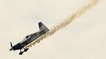 LONDON - JULY 31:  World Champion Mike Mangold of the USA flies his plane during a training session for the Red Bull Air Race World Series on July 31, 2008 in London, England.  (Photo by Daniel Berehulak/Getty Images)