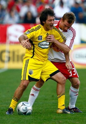 CARSON, CA - NOVEMBER 23:  Guillermo Barros Schelotto #7 of the Columbus Crew grimaces while being defended by Chris Leitch #33 of the New York Red Bulls during the 2008 MLS Cup match at The Home Depot Center on November 23, 2008 in Carson, California. Th