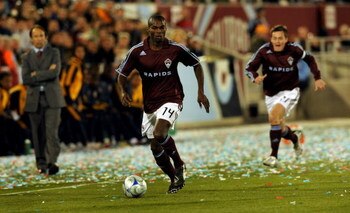 COMMERCE CITY, CO - MARCH 29:  Omar Cummings #14 of the Colorado Rapids controls the ball and heads upfield as head coach Fernando Clavijo (L) and teammate Terry Cooke #11 trail the play during the MLS soccer game against the Los Angeles Galaxy at Dick's 