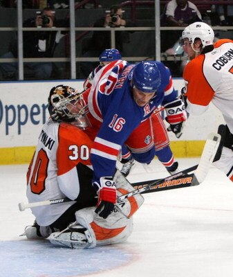 NEW YORK - MARCH 15:  Antero Niittymaki #30 of the Philadelphia Flyers is run over by Sean Avery #16 of the New York Rangers who took a penalty for goaltender interference on March 15, 2009 at Madison Square Garden in New York City.  (Photo by Bruce Benne