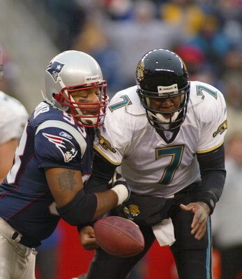 FOXBORO, MA - DECEMBER 14:  Richard Seymour #93 of the New England Patriots strips the ball from Brian Leftwitch #7 of the Jacksonville Jaguars on December 14, 2003 at Gillette Stadium in Foxboro, Massachusetts.  (Photo by Rick Stewart/Getty Images)