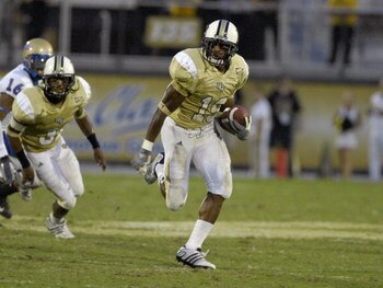 ORLANDO, FL - OCTOBER 20: Defensive back Joe Burnett #19 of the University of Central Florida Golden Knights rushes upfield against the Tulsa Golden Hurricane at Bright House Stadium on October 20, 2007 in Orlando, Florida.  UCF won 44 - 23. (Photo by Al 