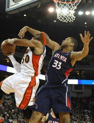OAKLAND, CA - JANUARY 16: Randolph Morris #33 of the Atlanta Hawks defends Corey Maggette #50 of the Golden State Warriors during an NBA game on January 16, 2009 at Oracle Arena in Oakland, California. NOTE TO USER: User expressly acknowledges and agrees 