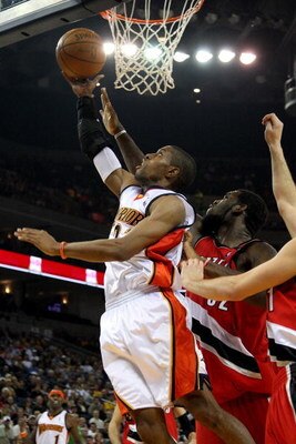 OAKLAND, CA - NOVEMBER 18:  C.J. Watson #23 of the Golden State Warriors goes to the basket against Greg Oden #52 of the Portland Trail Blazers during the game on November 18, 2008 at Oracle Arena in Oakland, California.  The Warriors won 111-106.   NOTE 