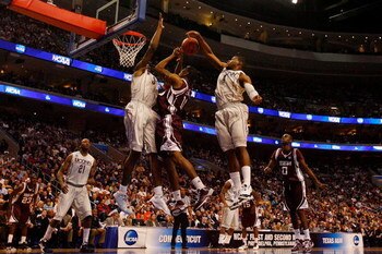PHILADELPHIA - MARCH 21:  David Loubeau #10 of the Texas A&M Aggies shoots against Hasheem Thabeet #34 and Jeff Adrien #4 of the Connecticut Huskies during the second round of the NCAA Division I Men's Basketball Tournament at the Wachovia Center on March