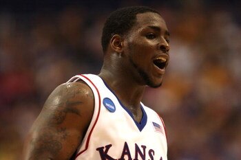 MINNEAPOLIS - MARCH 22:  Sherron Collins #4 of the Kansas Jayhawks reacts on court in the final minutes of Kansas' 60-43 win against the Dayton Flyers during the second round of the NCAA Division I Men's Basketball Tournament at the Hubert H. Humphrey Met