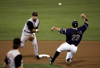 SAN DIEGO - SEPTEMBER 01:  Shortstop Rich Aurilia #33 of the Cincinnati Reds turns a double play as Adrian Gonzalez #23 of the San Diego Padres slides into 2nd base during their MLB Game at Petco Park on September 1, 2006 in San Diego, California.   (Phot