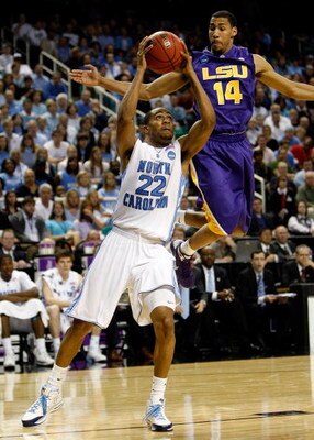GREENSBORO, NC - MARCH 21:  Wayne Ellington #22 of the North Carolina Tar Heels drives against Garrett Temple #14 of the Louisiana State University Tigers during the second round of the NCAA Division I Men's Basketball Tournament at the Greensboro Coliseu
