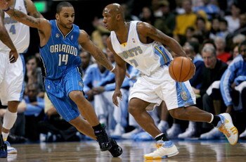 DENVER - JANUARY 17:  Chauncey Billups #7 of the Denver Nuggets drives against Jameer Nelson #14 of the Orlando Magic during NBA action at the Pepsi Center on January 17, 2009 in Denver, Colorado. NOTE TO USER: User expressly acknowledges and agrees that,
